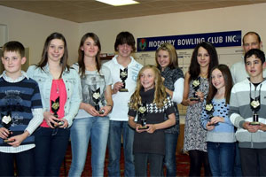 swimmers holding trophies